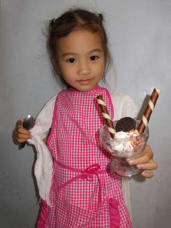 Cute little girl holding ice creamの写真素材