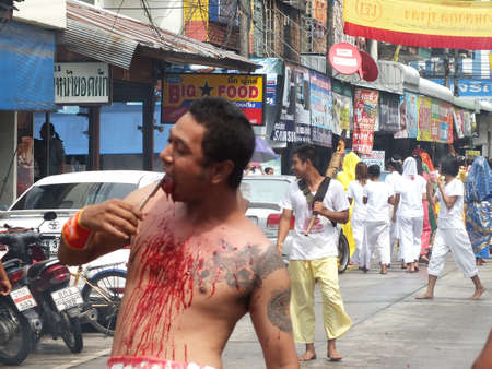 Nakhon si thammarat, Thailand - October 20, 2012 - Unidentified Thai men to be incarcerated with spirits in Chinese Vegetarian Festival parade on October 20, 2012 in Nakhon si thammarat, Thailand.のeditorial素材