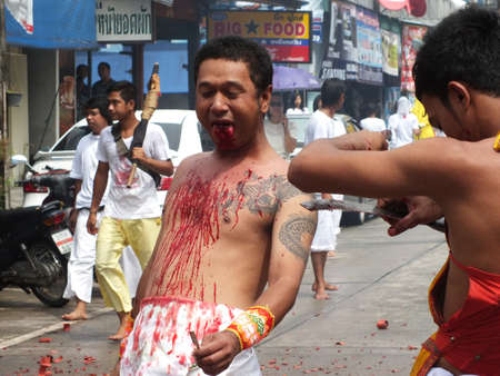 Nakhon si thammarat, Thailand - October 20, 2012 - Unidentified Thai men to be incarcerated with spirits in Chinese Vegetarian Festival parade on October 20, 2012 in Nakhon si thammarat, Thailand.のeditorial素材