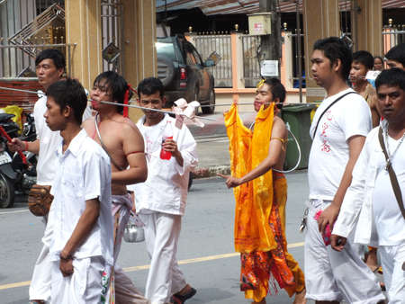 Nakhon si thammarat, Thailand - October 20, 2012 - Unidentified Thai men to be incarcerated with spirits in Chinese Vegetarian Festival parade on October 20, 2012 in Nakhon si thammarat, Thailand.のeditorial素材