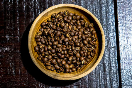Brewed black Robusta and Arabica coffee powder, roasted coffee beans and raw coffee beans.の写真素材