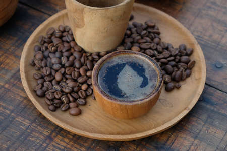 Brewed black Robusta and Arabica coffee powder, roasted coffee beans and raw coffee beans.の写真素材