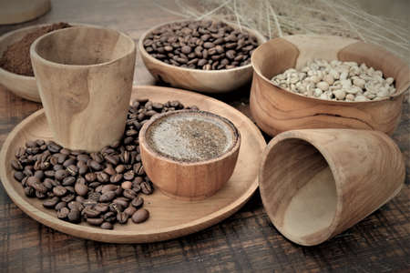 Brewed black Robusta and Arabica coffee powder, roasted coffee beans and raw coffee beans.の写真素材