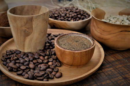 Brewed black Robusta and Arabica coffee powder, roasted coffee beans and raw coffee beans.の写真素材