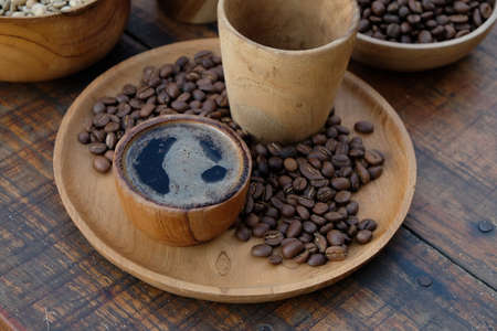 Brewed black Robusta and Arabica coffee powder, roasted coffee beans and raw coffee beans.の写真素材