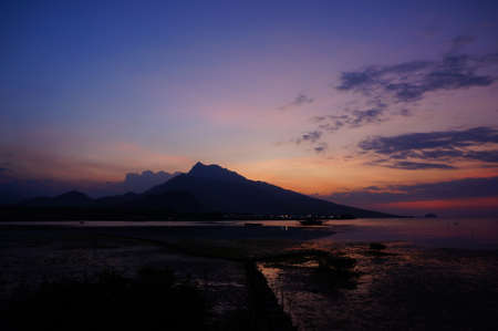 The sunset looks beautiful on the beach at duskの写真素材
