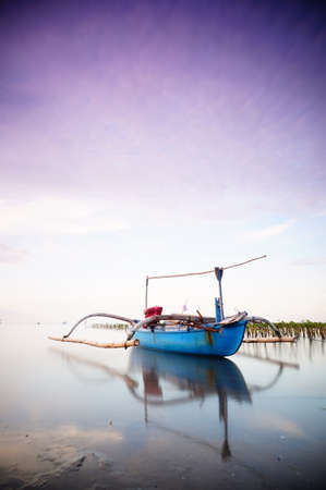 Traditional fishing vessels that still use traditional fishing gear, this boat is made of wood that is resistant to sea water. Fishing boats dock at the seashore.の写真素材