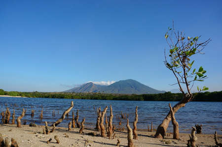Beach with clean white sand, beautiful beach with the background of the high seas and mountainsの写真素材