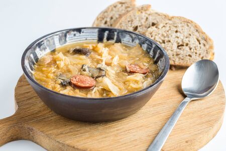 Christmas cabbage soup kapustnica with mushrooms on natural background.
