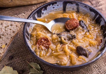 Christmas cabbage soup with mushrooms on natural background.