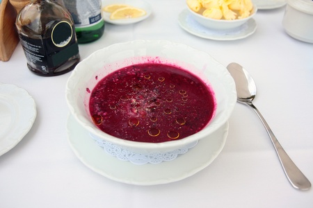 Cold beet soup with pomegranate kernels on the table