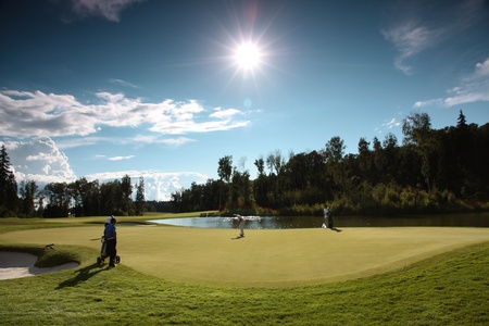 Golf  course, green grass, blue sky and white cloudsの写真素材