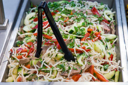 Red pepper and cucumber salad on a pan in a food store