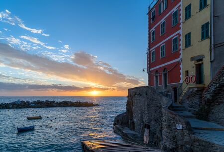 Riomaggiore in a sunset. It is one of colorful villages of Cinque Terre in Italy, suspended between sea and landの写真素材