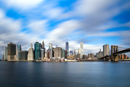 New York City Manhattan skyline with Brooklyn Bridge and skyscrapers over Hudson River in the morning after sunriseの写真素材