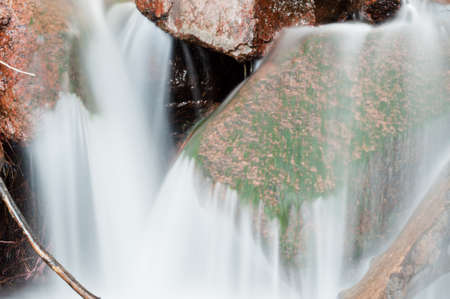 Close view of a small streem cascading over rocks.