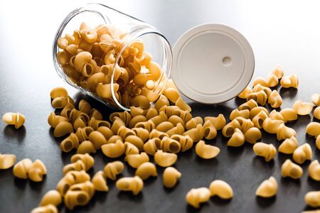 jar of pasta on a dark backgroundの写真素材