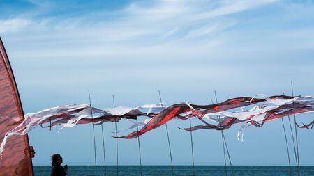 Cervia, Italy - May 1, 2015: International Kite Festival 2015, during the stop of the performances, the audience walks on the beach to watch the installation of sails positioned on the seashoreのeditorial素材
