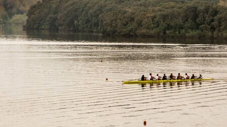 Sabaudia, Italy - April 18, 2015: a rowing team performs a morning workout in the lake of Paola. Lake Paola also called "Laguna" "Sabaudia" or Sabaudia lake is a brackish lake in the coastal provinces of Latina in the Circeo National Parkのeditorial素材