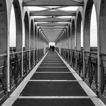 Civitavecchia, Italy - March 29, 2015: at sunset, some people walking on the old dock of the seafront in Civitavecchia.のeditorial素材