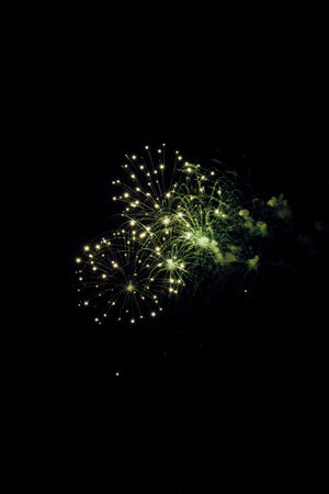 Close-up of colorful fireworks in the sky at nightの写真素材