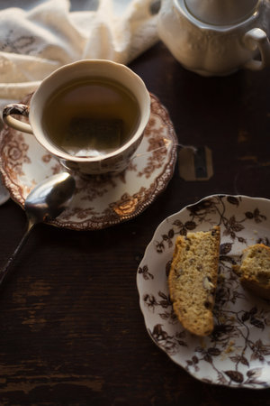 Overhead photo of a cup of tea and biscotti in morning lightの写真素材
