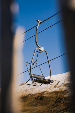 Chairlift going up the mountain at the beginning of the ski seasonの写真素材