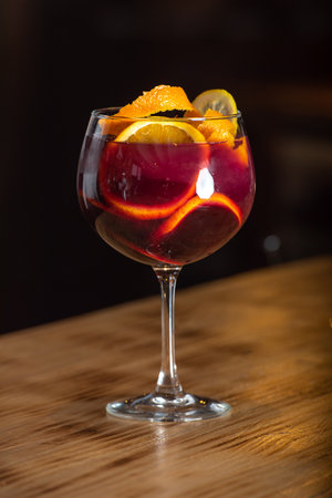 Sangria drink in glass isolated on a wooden table.の写真素材