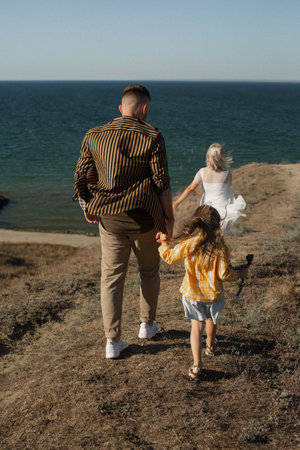 Family walking near the seaの写真素材
