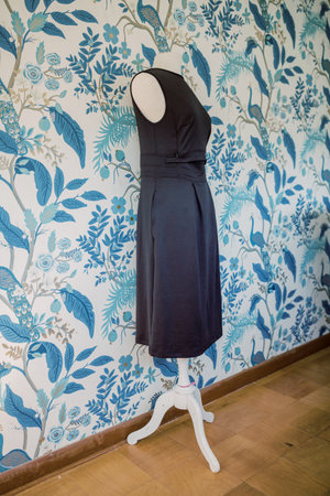 Professional black dress for pumping moms on bust with blue wallpaper.の写真素材