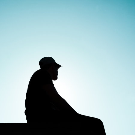 man silhouette portrait with a blue sky backgroundの写真素材