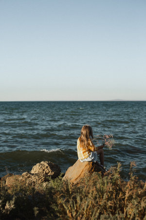 Girl near the black seaの写真素材