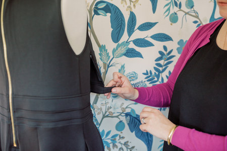 Caucasian female opens latch on black pumping dress for moms.の写真素材
