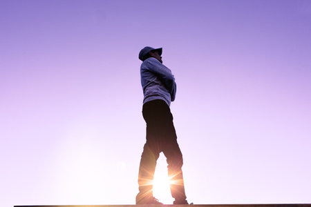 man trekking in the mountain with sunset backgroundの写真素材