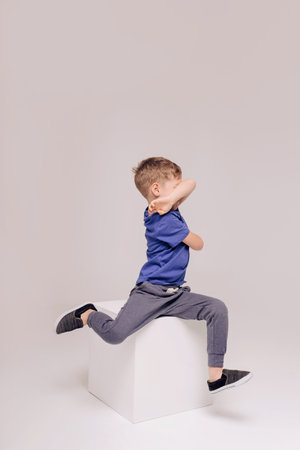 Half-length emotional portrait of caucasian teen boy wearing blue t-shirt. Surprised teenager looking at camera. Handsome happy child, isolated on white background.の写真素材