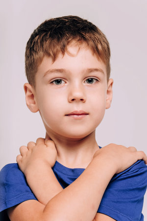 Half-length emotional portrait of caucasian teen boy wearing blue t-shirt. Surprised teenager looking at camera. Handsome happy child, isolated on white background.の写真素材