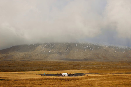 Car in field near mountainの写真素材