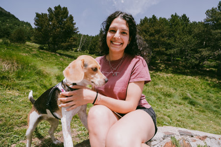 Latin young girl whit a dog in the mountains of Andorra.の写真素材