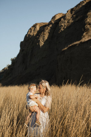 Mother and daughter in the fieldの写真素材