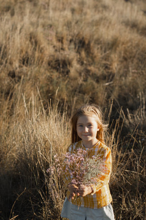 Girl in a field with flowersの写真素材