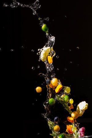 thrown in the air of vegetables and fruits in waterの写真素材