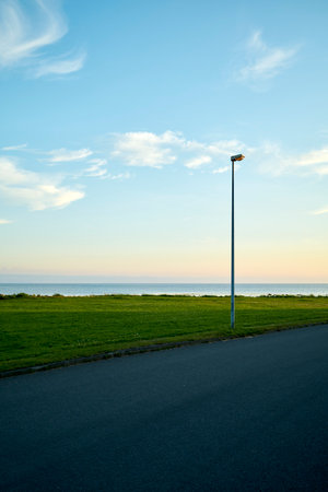 Road near sea at sunsetの写真素材