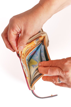 woman taking euro banknotes out of her walletの写真素材