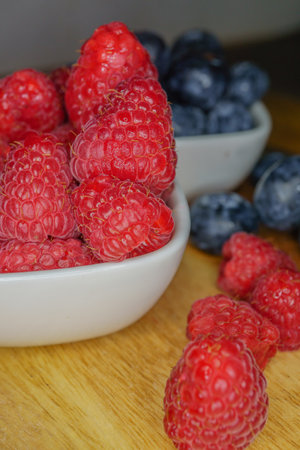 raspberries in a white ceramic bowlの写真素材