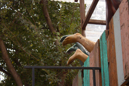 Legs of mannequins of different colors behind the fenceの写真素材