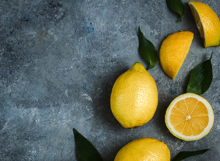 Fresh Citrus lemon With Leaves on gray texture backgroundの写真素材