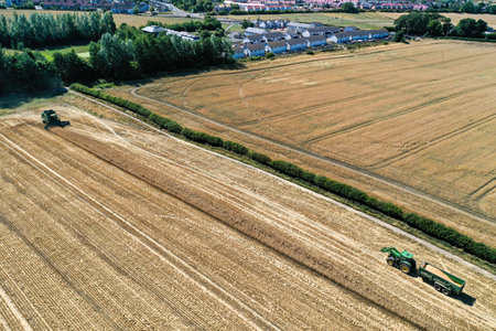 Aerial drone view of a tractor tilling the landのeditorial素材