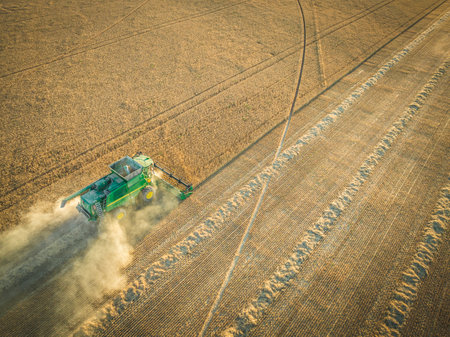 combine harvester working over corn field from aerial point of viewのeditorial素材