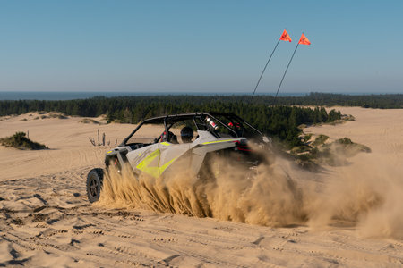 Dune buggy sprays sand at Oregon Dunesのeditorial素材
