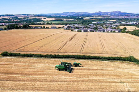 Aerial drone view of a tractor tilling the landのeditorial素材